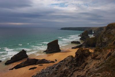 Bedruthan Steps from the cliff top, with a storm brewing out to
