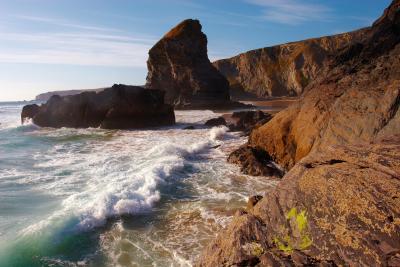 Waves breaking on the rocky shore at Bedruthan Steps