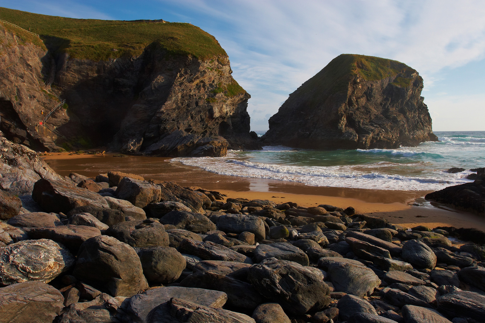 Waves washing onto the beach and boulders at Bedruthan Steps