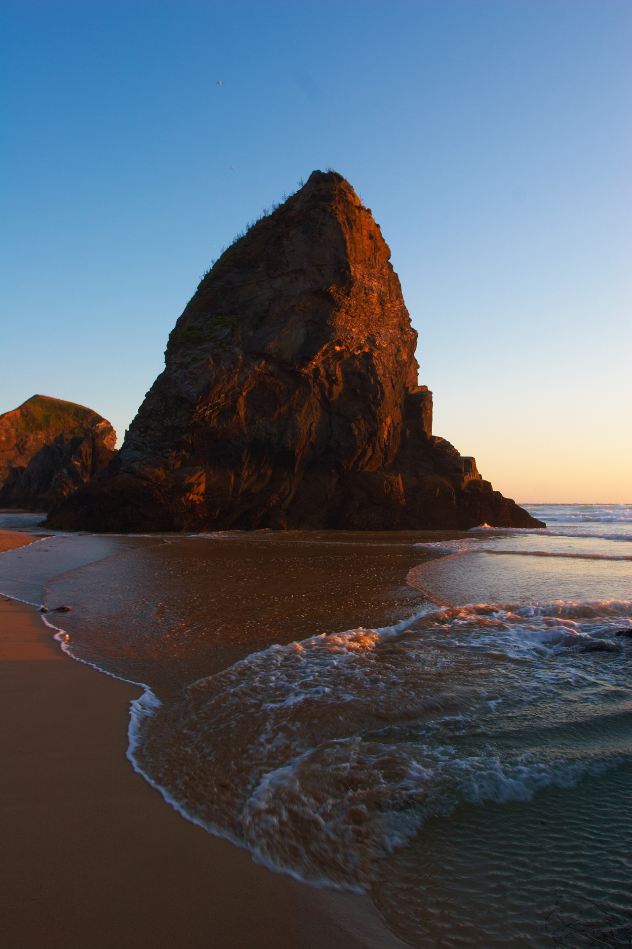 Rock outcrop at Bedruthan Steps illuminated by the setting sun