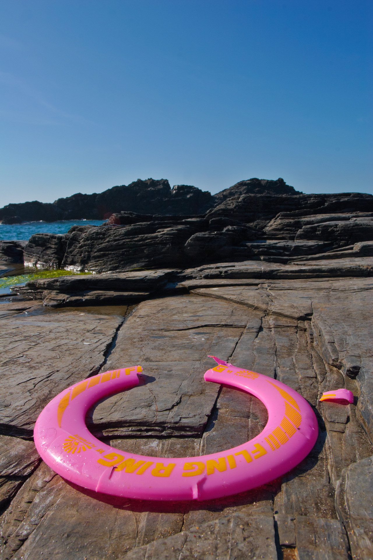 Abandoned Frisbee on the rocks at Will's Rock near Porthcothan i