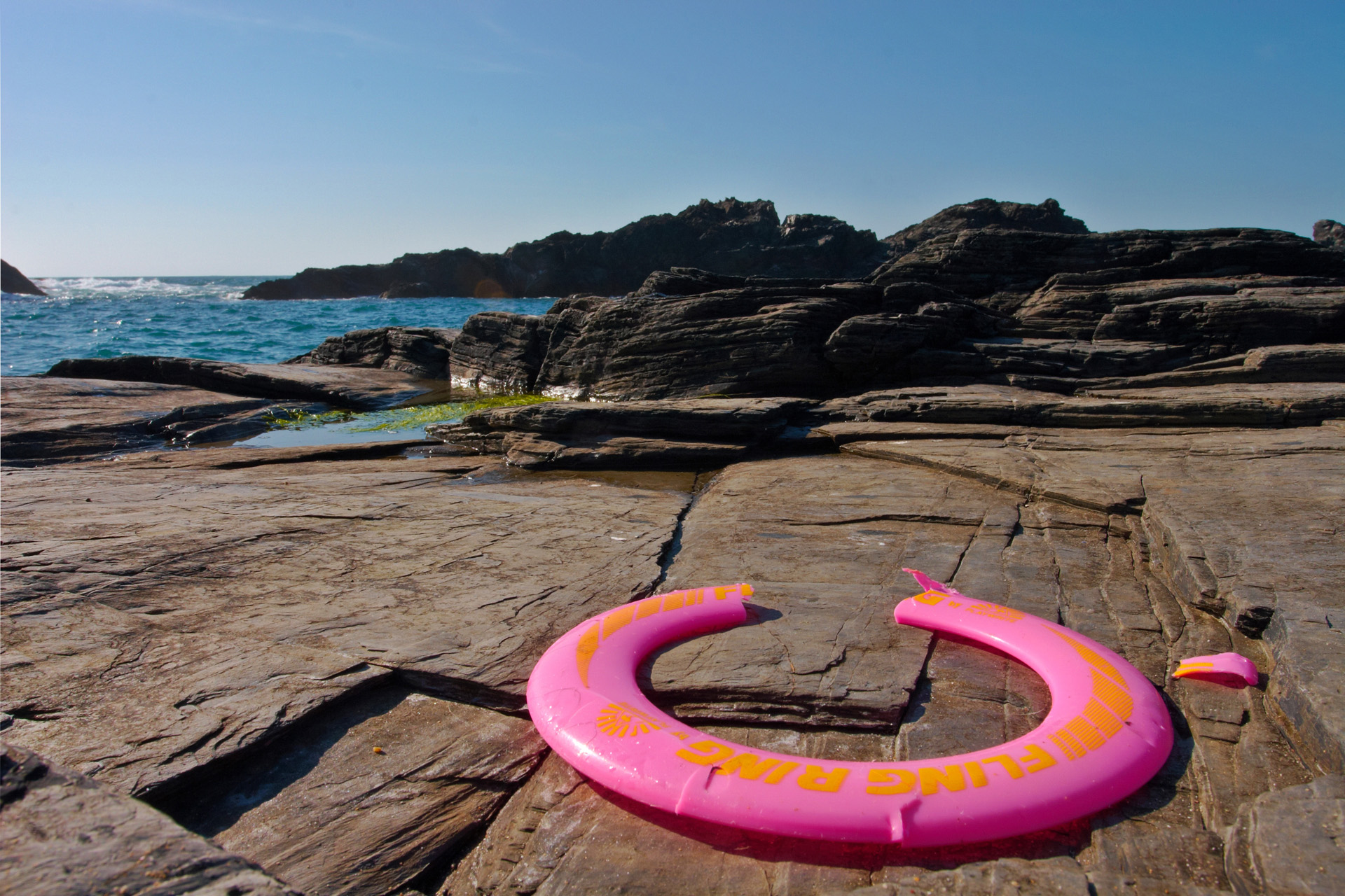 Abandoned Frisbee on the rocks at Will's Rock near Porthcothan i