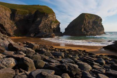 Waves washing onto the beach and boulders at Bedruthan Steps